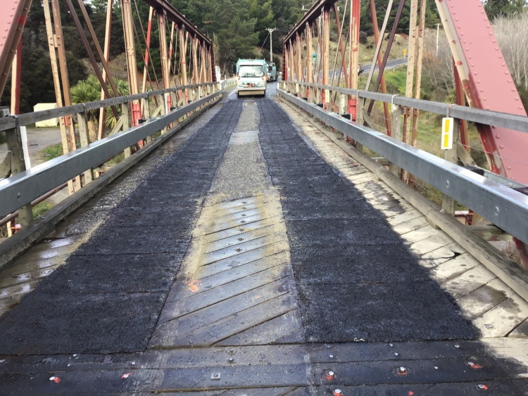 an incoming vehicle on a narrow bridge with a single lane