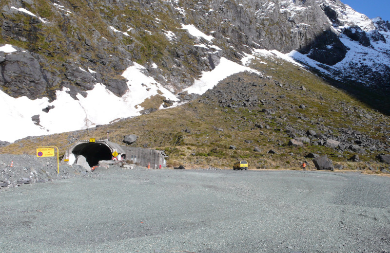 photo showing the current status of the site at Homer tunnel side entrance with a parked yellow service vehicle at a distance 