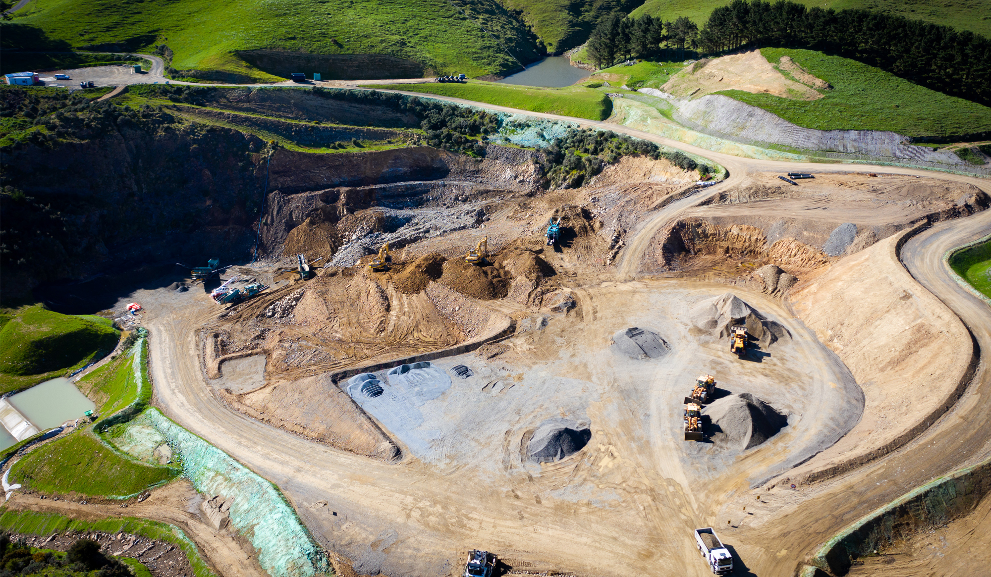 Aerial view of Willowbank Quarry with earth movers operating.