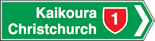 Green directional sign pointing right has Kaikoura and Christchurch with a red state highway 2 symbol