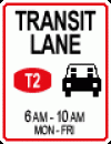 Regulatory traffic sign with four lines of text and it has a red border around the sign. The top line says transit lane. The middle line has a T2 icon and a car icon next to each other. The third line in smaller print says 6am-10am. The fourth line also has Mon-Fri in smaller print. 